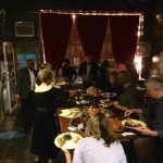 People gather for a dinner party in a restaurant.