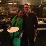 Couple smiling in restaurant with plate