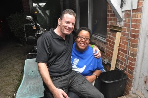 Two people smiling, man with arm around woman.