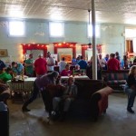 People gather in a bar with a pool table.