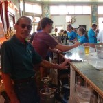 Group of people at a bar with drinks.