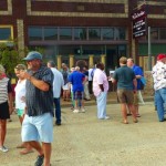 Group of people gathered outside a building.