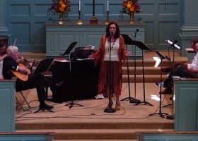 Woman singing in church with musicians.