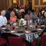 Group of people gathered around a table.