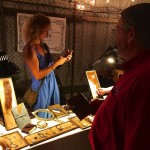 Two people shopping for jewelry at a market.