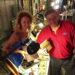 Two people selling jewelry at a night market.