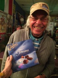 Man holding a box of Cailler chocolate.