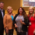 Four people at an awards ceremony.