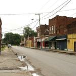 Empty street lined with brick buildings.