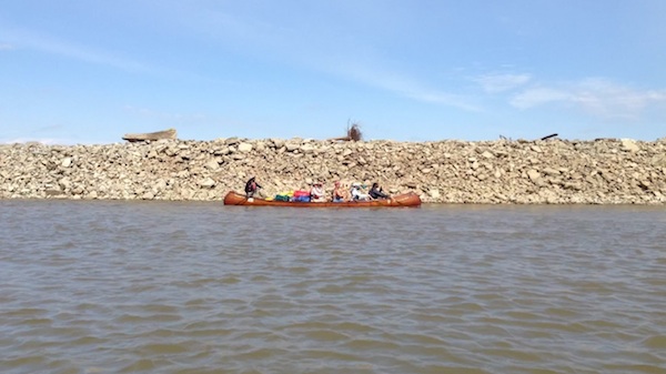 Mark River Peoples guides a canoe with paddlers on the Mississippi River