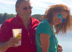 Man in red shirt with woman in blue shirt.