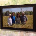 Framed photo of four people in a field.