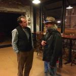 Two men talking in a restaurant.