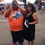 A young boy and woman smiling for a photo.