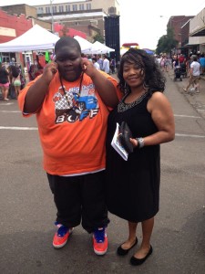 A young boy and woman smiling for a photo.