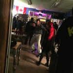 Group of people at a party in a room.