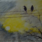 Two birds perched on a wire against a sunset.