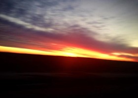 Sunset with colorful clouds and horizon.