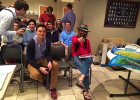 Group of young men sitting and talking.