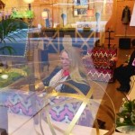 Woman with blonde hair sitting in a store.