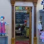 Ornate doorway with a chalkboard and rug.