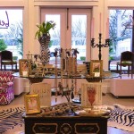 A black dresser with gold accents in a shop.