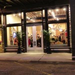 A storefront with "Bella" sign and glass doors.