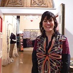 Woman in a boutique smiling at the camera.