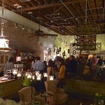 A crowded restaurant with a chandelier