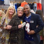 Group of people shopping in a clothing store.