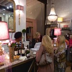 Women shopping in a boutique with a chandelier.