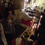 Woman drinking coffee in a dimly lit room.