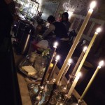 Candles and silver candle holders on a table.