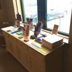 Brochures on a wooden table in a room.