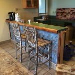 Two stools at a rustic bar counter.