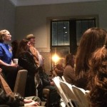 Group of people seated in a room.