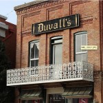 Brick building with Duvall's sign and balcony.