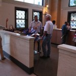 Group of people standing around a counter.