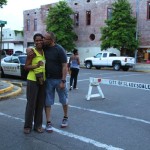 Couple smiling in front of a brick building.