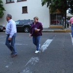 Two people walking across a crosswalk.