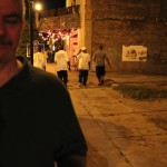 Man with a beard facing the camera at night.