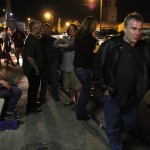 Group of people standing outdoors at night.