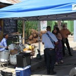 A band playing under a blue awning.