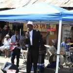 Man in a suit playing music with a band.