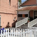 White picket fence in front of a building.