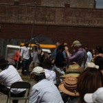 Group of people gathered in front of a building.