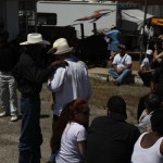 Group of people wearing cowboy hats and sunglasses.