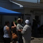 People gather under a canopy at a blues club.