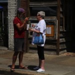 Two people standing outside a building.