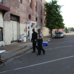 Two security guards in front of a building.